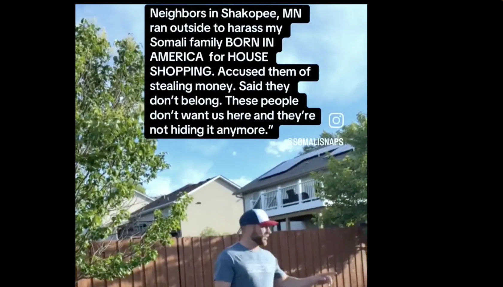 A person standing in a residential yard, with text overlay stating that neighbors in Shakopee, Minnesota harassed the person
